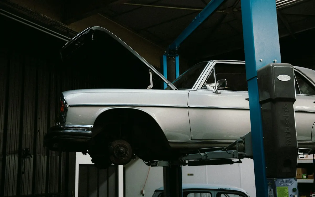 European sedan on a lift in a workshop bay — South OC help for brakes and Euro repair